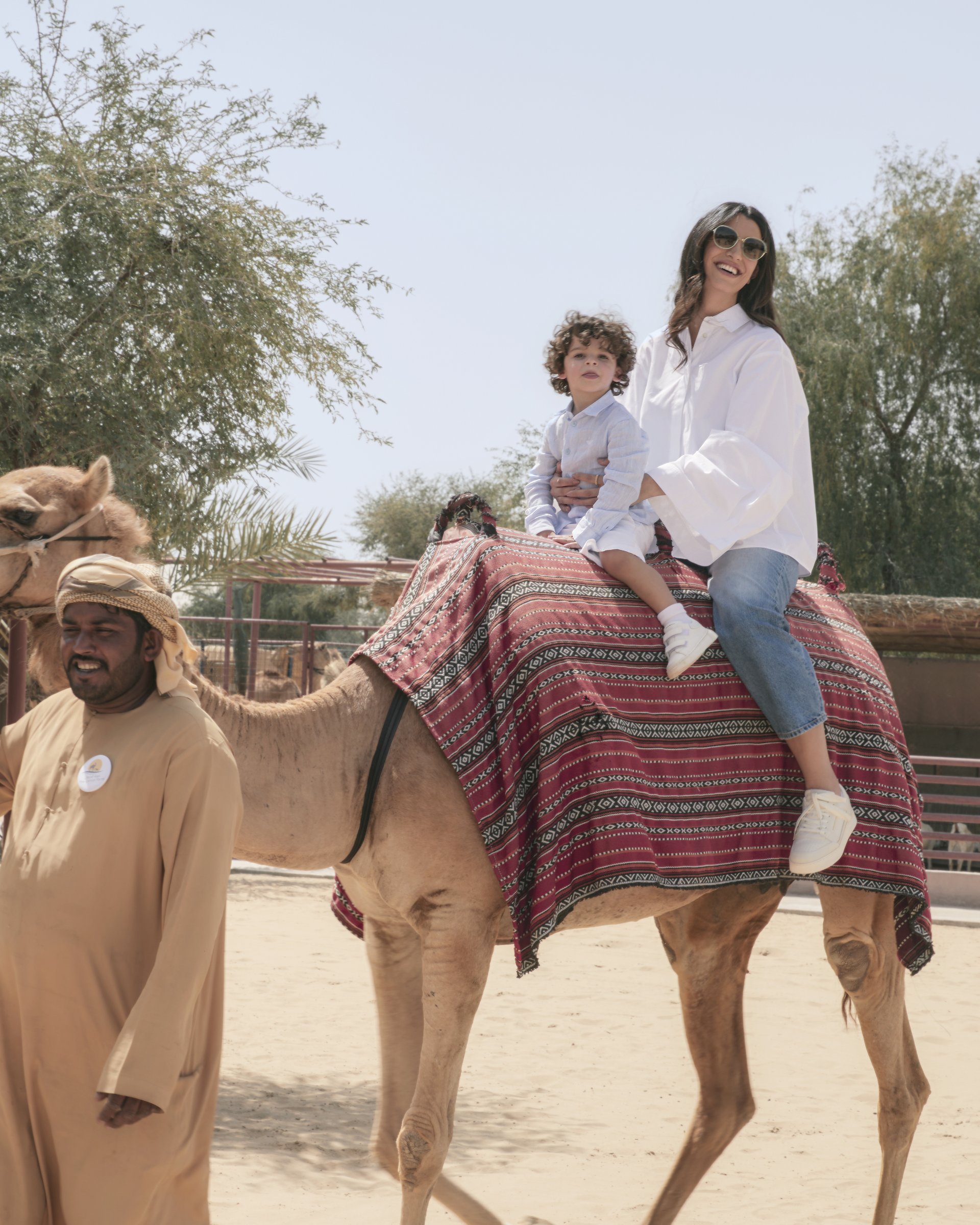 Walaa and Aboudi riding a camel together — Emporio Armani
      campaign by Ali & Walaa, April 2024
