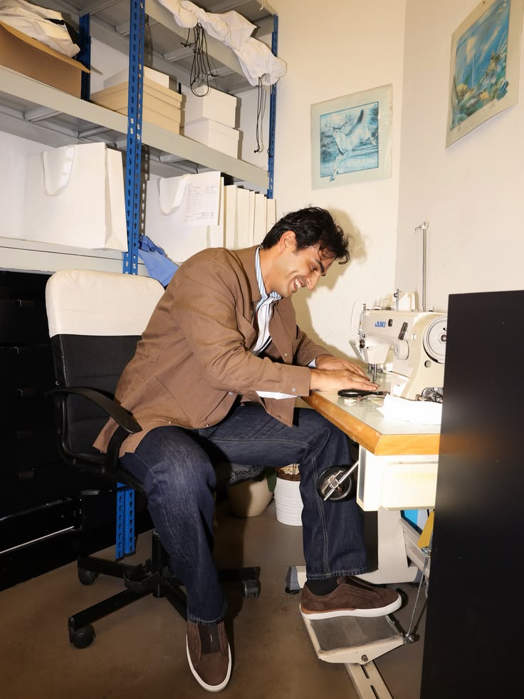 Ali Hennaoui laughing at a sewing machine in a Dubai
      tailor's atelier — Fendi campaign content by Ali & Walaa
      (@aliandwalaa), May 2026