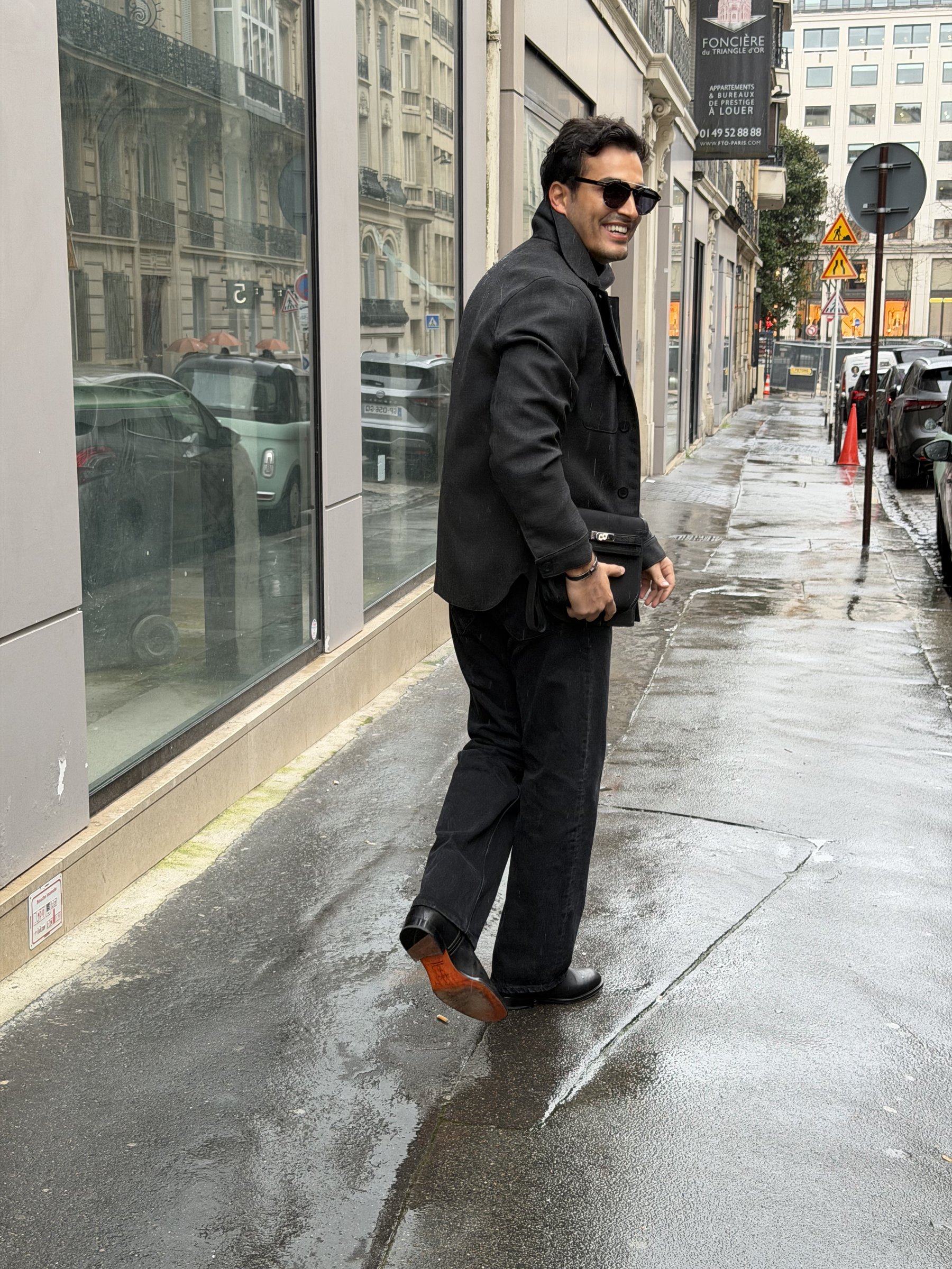 Ali Hennaoui in the rain on a Paris street ahead of the Hermès menswear show