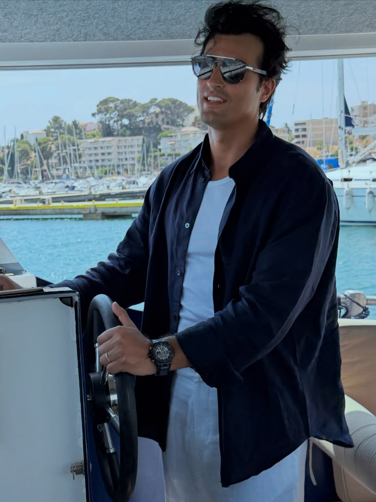 Ali Hennaoui at the helm of a boat on the French Riviera —
      Mercedes-Maybach experience, June 2026, Ali & Walaa
