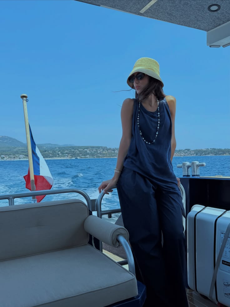 Walaa Awada on a boat with the French flag, Côte d'Azur —
      Mercedes-Maybach experience campaign, Ali & Walaa