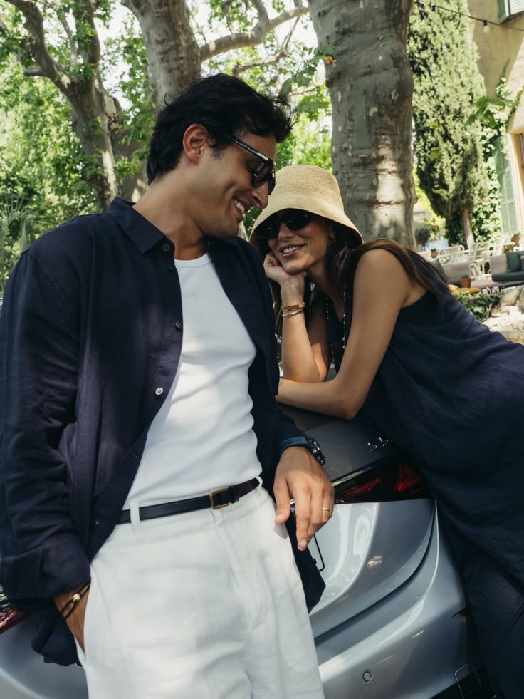 Ali Hennaoui and Walaa Awada laughing together leaning on the Mercedes-Maybach
    S-Class under plane trees at a Côte d'Azur villa — luxury campaign content by
    Ali & Walaa (@aliandwalaa)