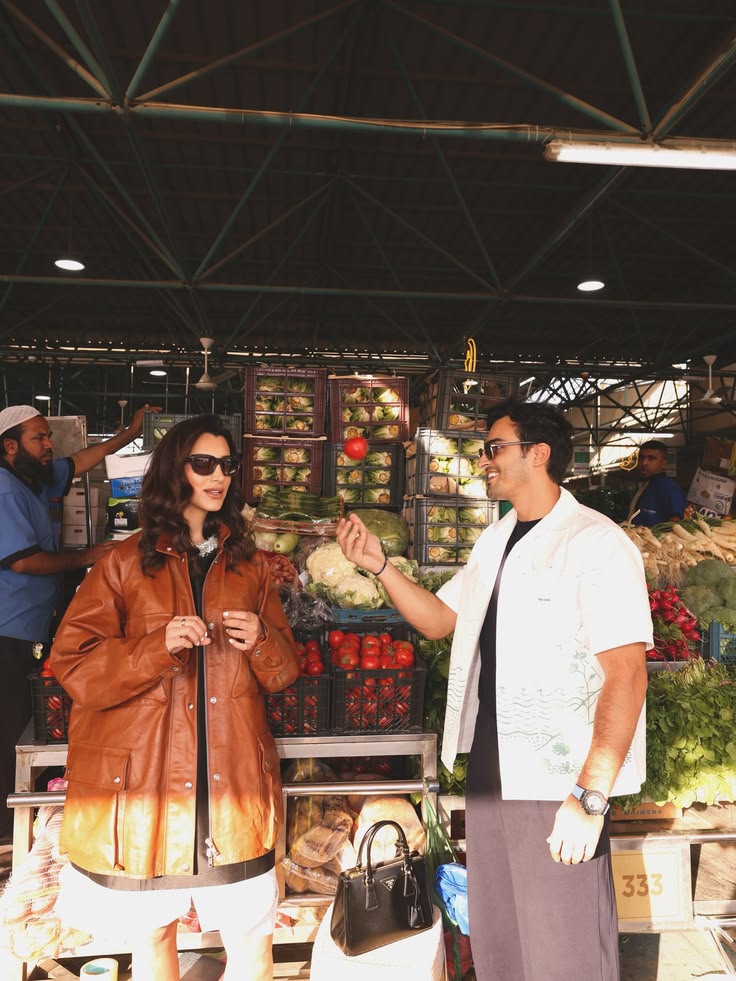 Ali Hennaoui and Walaa Awada at the Ras Al Khor market,
      Ali tossing a tomato — Prada Spring-Summer 2026 campaign
      by Ali & Walaa, Dubai
