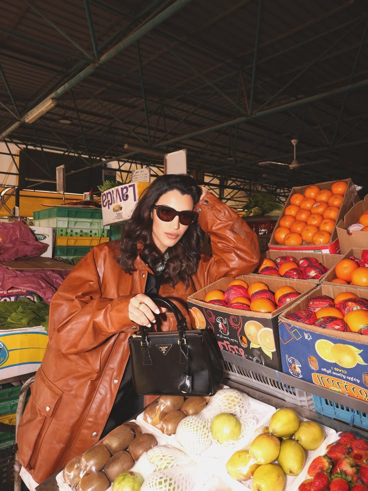 Walaa Awada profile in Prada SS26 leather jacket and
      Prada sunglasses at Ras Al Khor market Dubai — editorial
      campaign by Ali & Walaa 2026