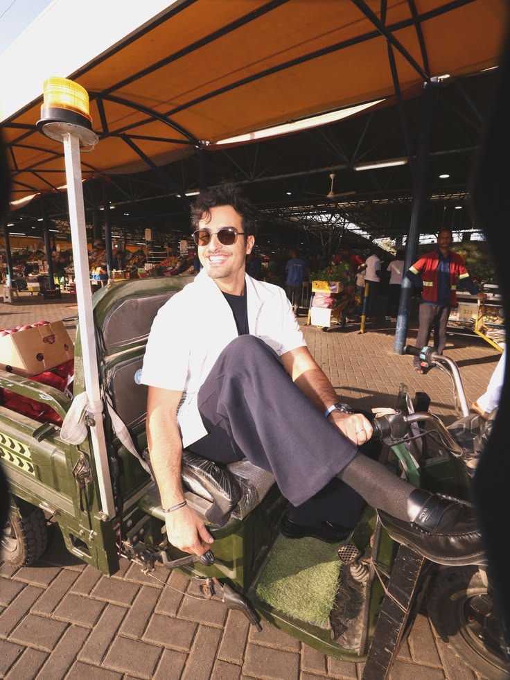 Ali Hennaoui in Prada sitting on a market vehicle at
      Ras Al Khor Dubai — Prada Spring-Summer 2026 campaign
      by Ali & Walaa (@aliandwalaa)